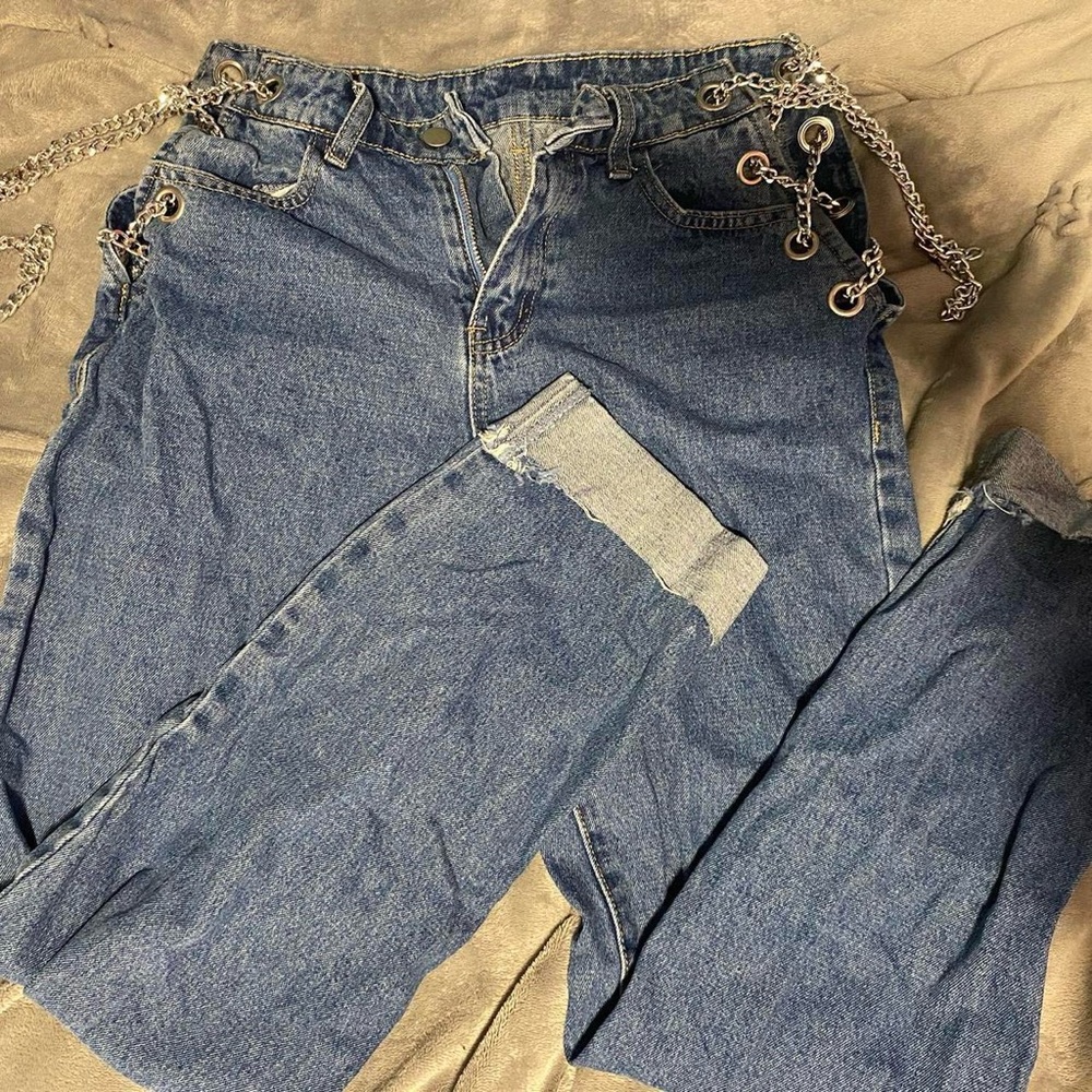 Low Rise Blue Denim Jeans. Cuffed at the Bottom With Chains.